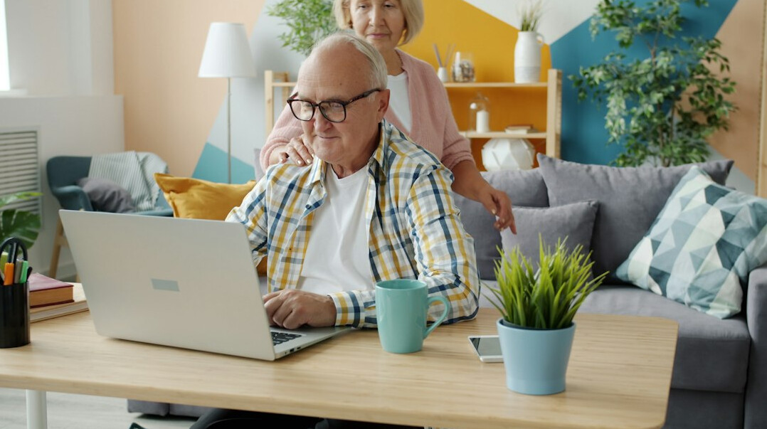 senior using laptop finance