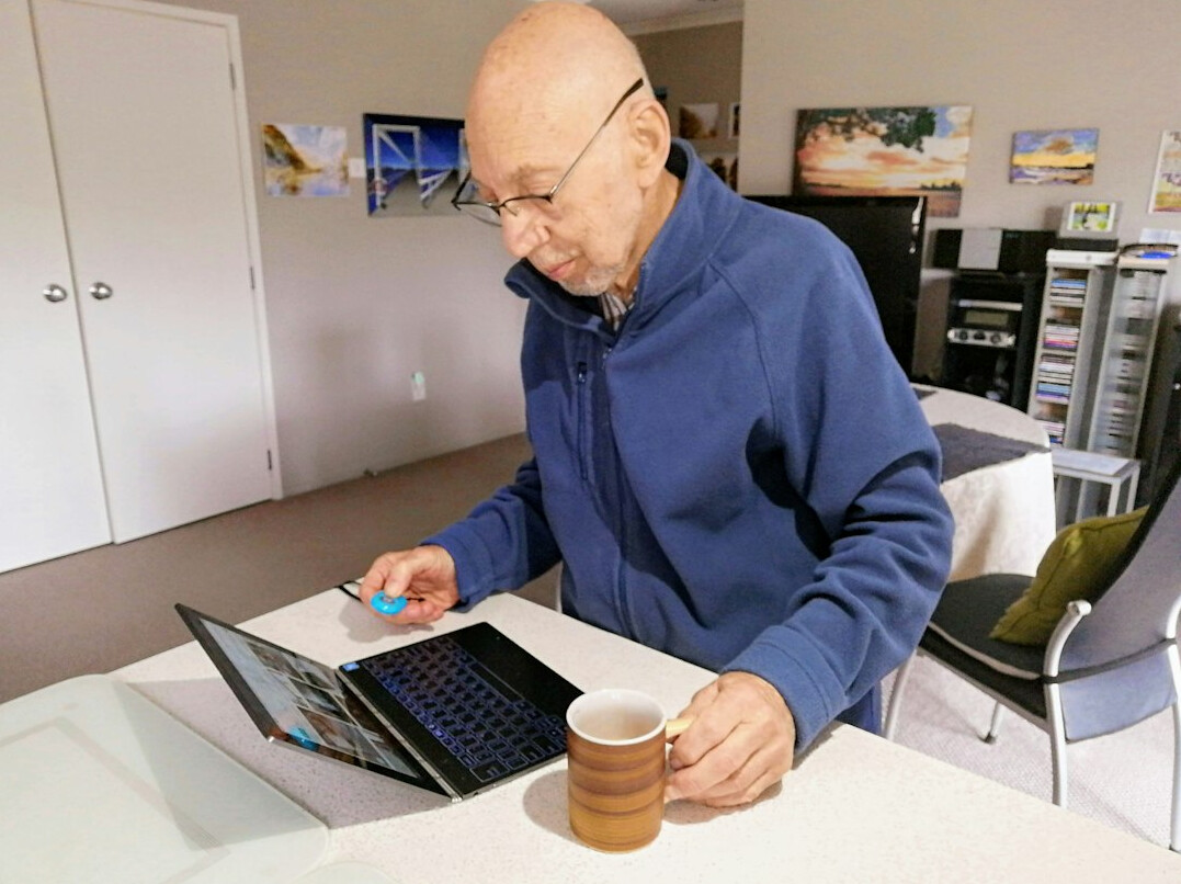 elderly person using laptop